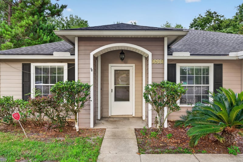 Front entry door with arched portico at 1648 Glen Laurel Dr, Middleburg, FL 32068