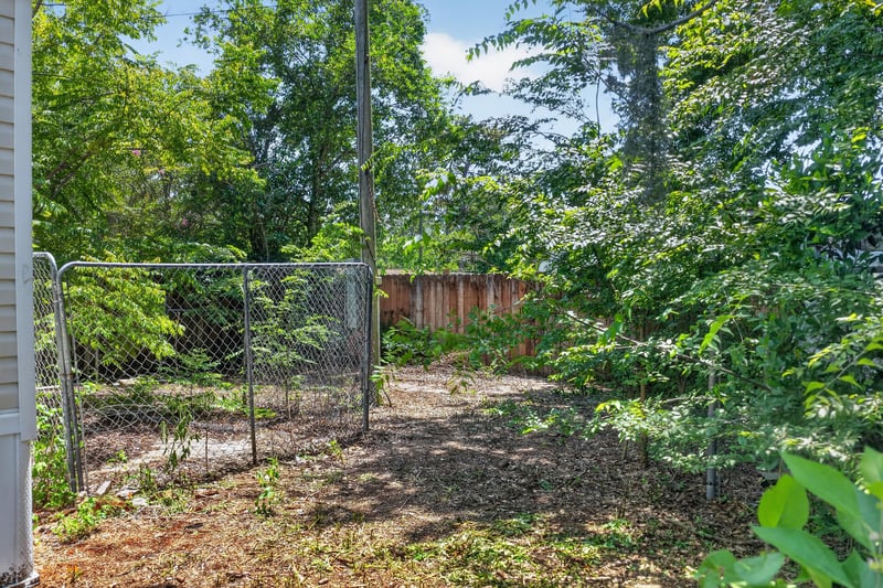 Backyard with chain-link gate and fence at 7603 Coach Park Dr, Jacksonville, FL 32244