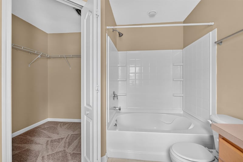 Closet with shelving beside tub-shower bath at 12359 Mangrove Forest Ct, Jacksonville, FL 32218