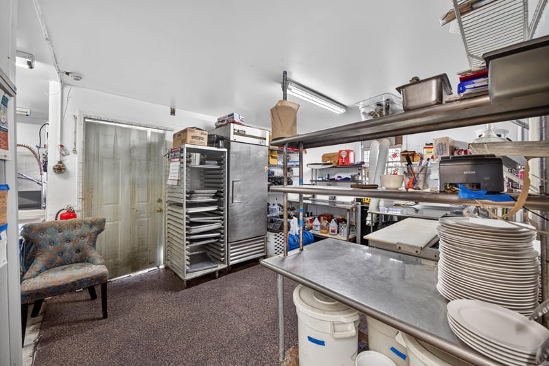 Kitchen prep area with shelving and supplies at 115 Cordova St, St. Augustine, FL