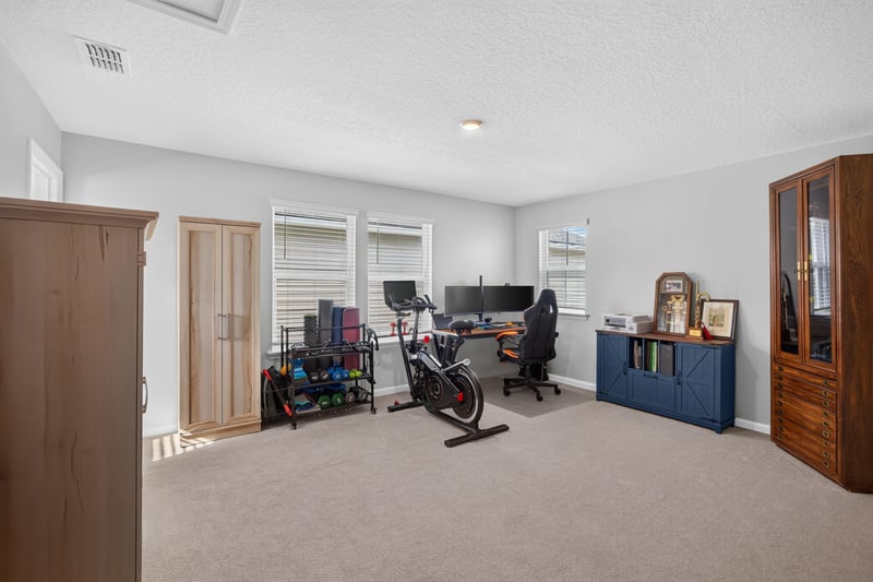Flex room with exercise bike and storage cabinet at 2354 Jennings Farm Dr, Middleburg, FL 32068