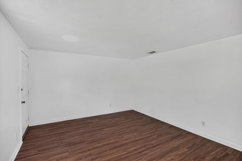 Empty room with wood-look flooring at 5812 Tampico Rd, Jacksonville, FL 32244