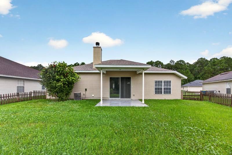 Backyard with chimney and open lawn at 706 Bonaparte Dr, Jacksonville, FL 32218