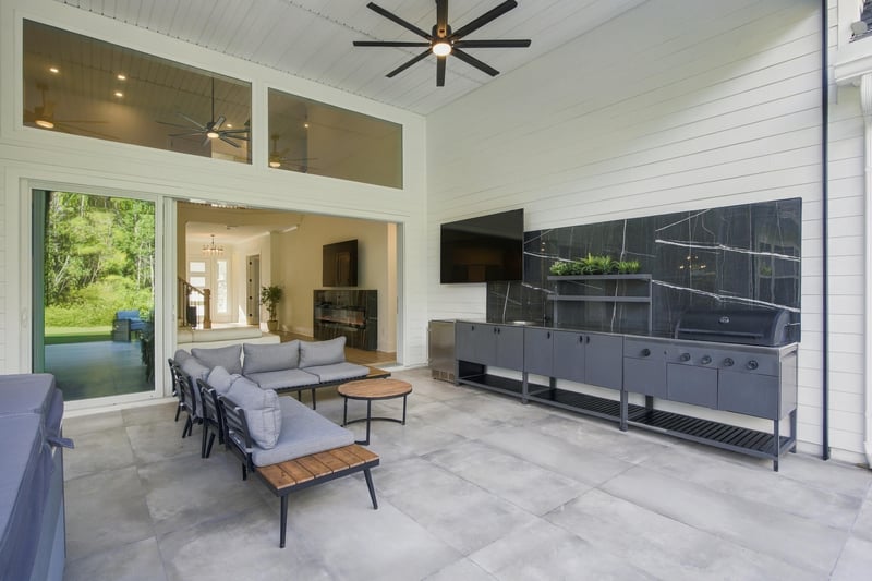 Covered patio with TV and lounge seating at 907 Seagrove Dr, Ponte Vedra Beach, FL 32081
