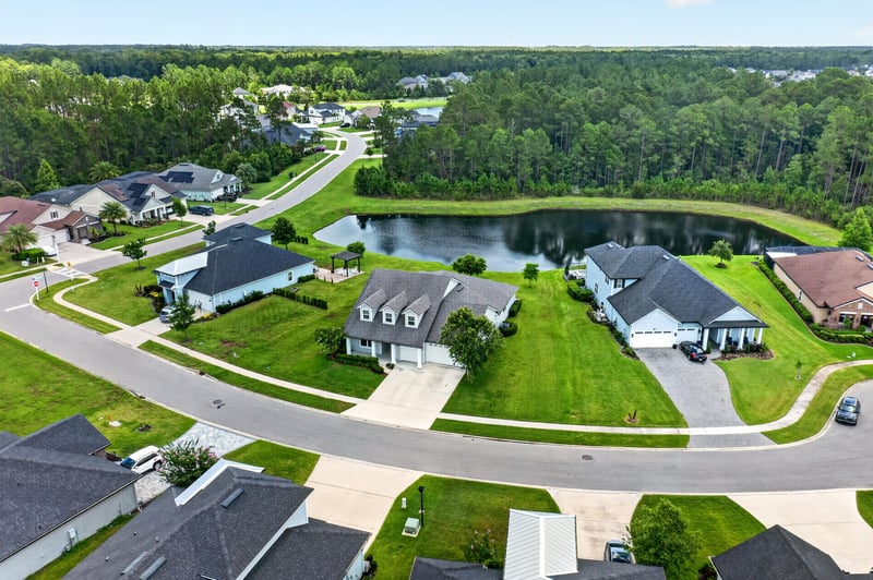 Aerial view of pond and rooftops near the home's street in St. Augustine, FL