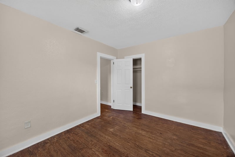 Empty room with closet and wood floors at 1473 State St W, Jacksonville, FL 32209