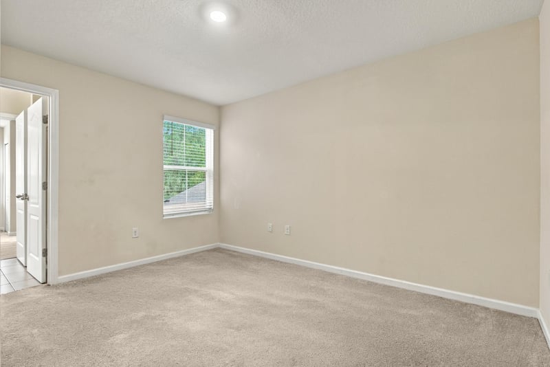 Empty bedroom with window and carpet at 9555 Star Dr, Jacksonville, FL 32256