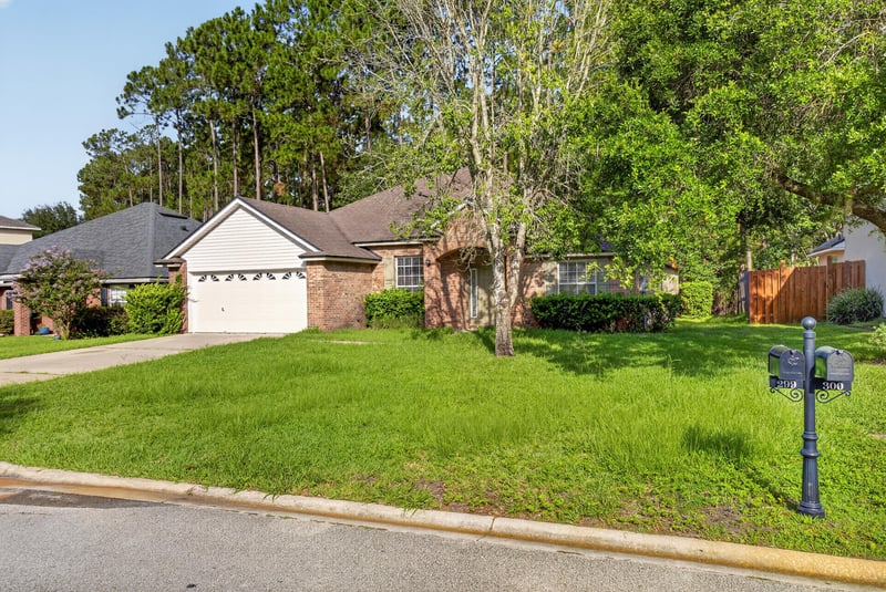 Street view of brick home with mailbox and lawn at 299 John's Creek Pkwy, St. Augustine, FL 32092