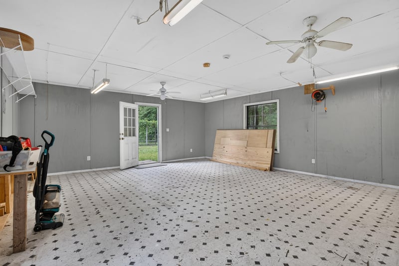 Outbuilding interior with ceiling fans and tools at 2549 Snapdragon Ave, Middleburg, FL 32068