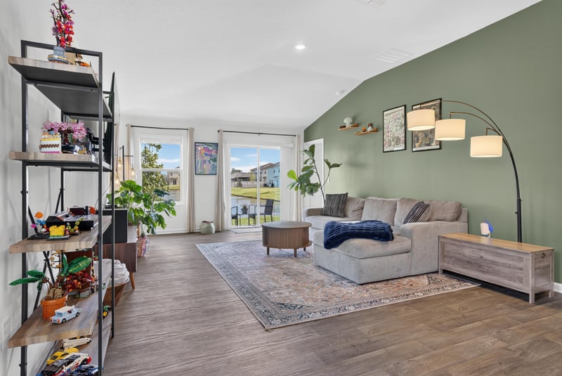 Living room with shelving unit and sofa at 4276 Quaking St, Jacksonville, FL 32218