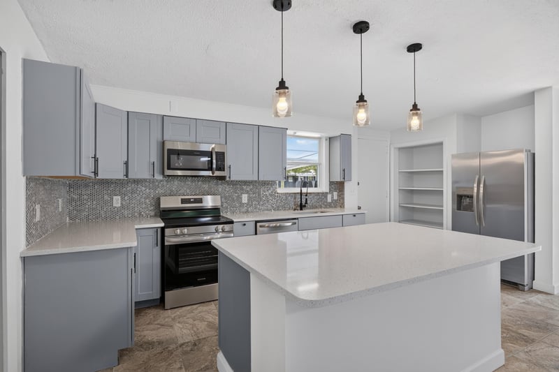 Staged kitchen island with white countertop at 3113 Kline Rd, Jacksonville, FL 32246