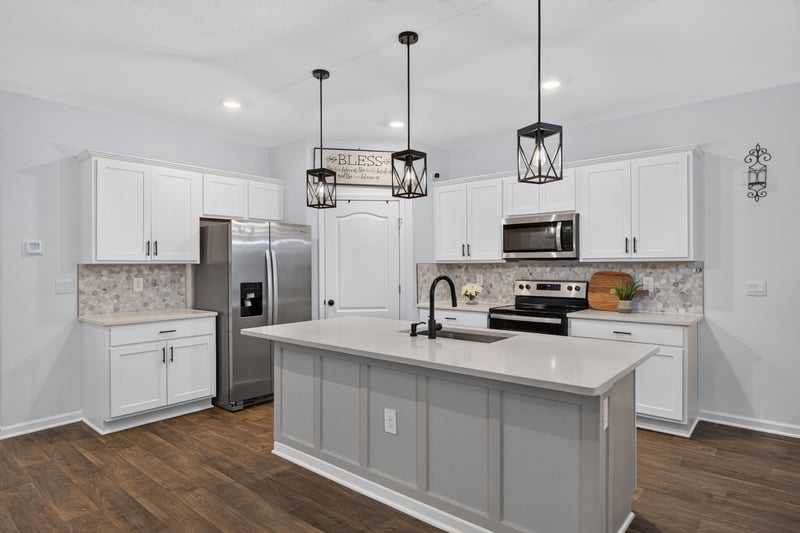 Kitchen with white cabinets and center island at 65255 Frst Glen Ln, Yulee, FL 32097
