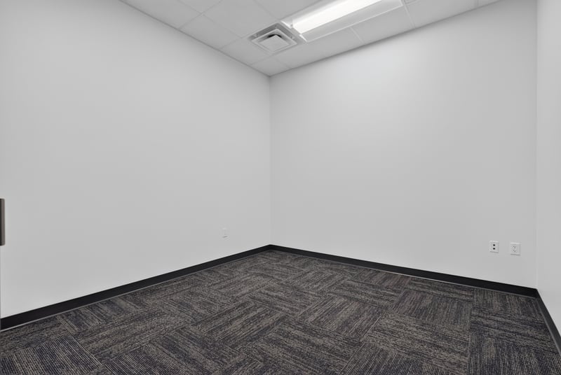 Empty corner room with carpet flooring at 7240 Golden Wings Rd building 100, Jacksonville, FL 32244