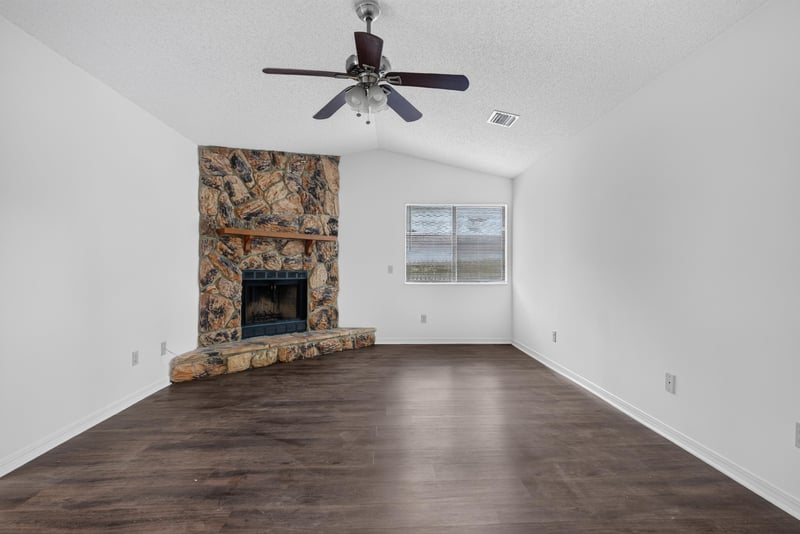 Living room fireplace and window view at 1445 Classic Oak Rd W, Jacksonville, FL