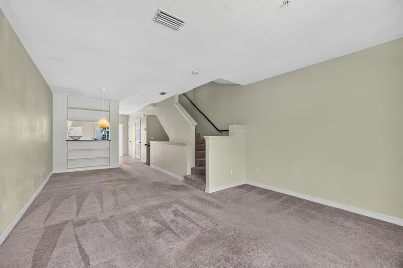 Living room with staircase and carpet flooring at 342 E Ashley St, Jacksonville, FL 32202