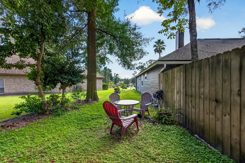 Backyard patio with red chairs along the fence at 1346 Gately Ct, Jacksonville, FL 32225