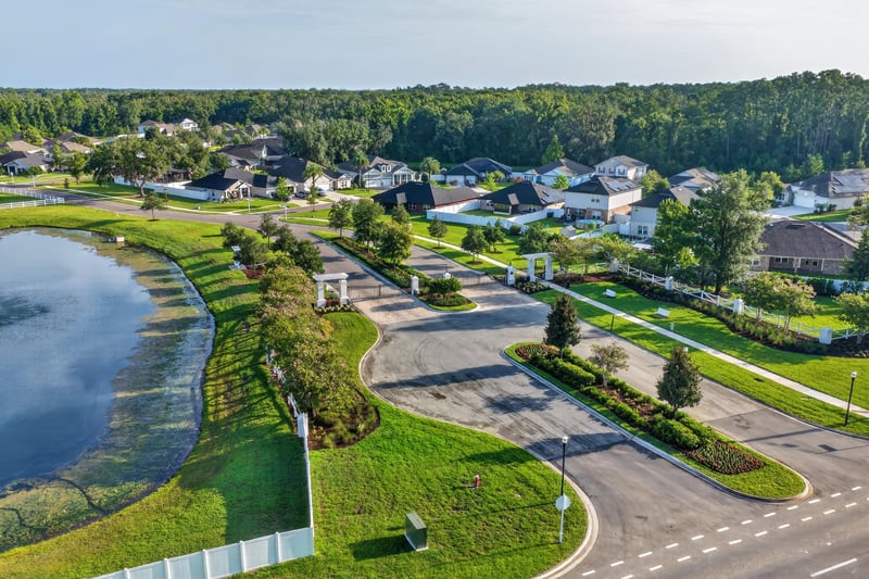 Aerial view of the community lake and homes in Green Cove Springs, FL