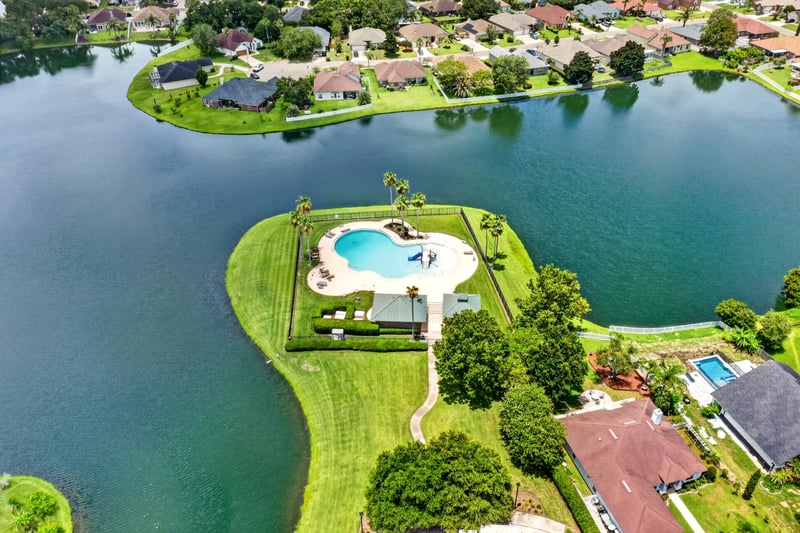 Aerial view of the community pool and surrounding lake in Windsor Chase