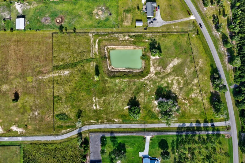 Aerial view with boundary lines over the pond and surrounding lot at 7500 Lucky Seven Rnch Rd, Macclenny, FL
