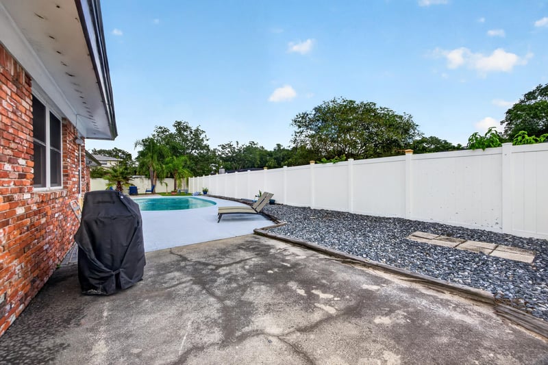 Pool patio with lounge chair and grill at 6059 Karen St, Jacksonville, FL 32244