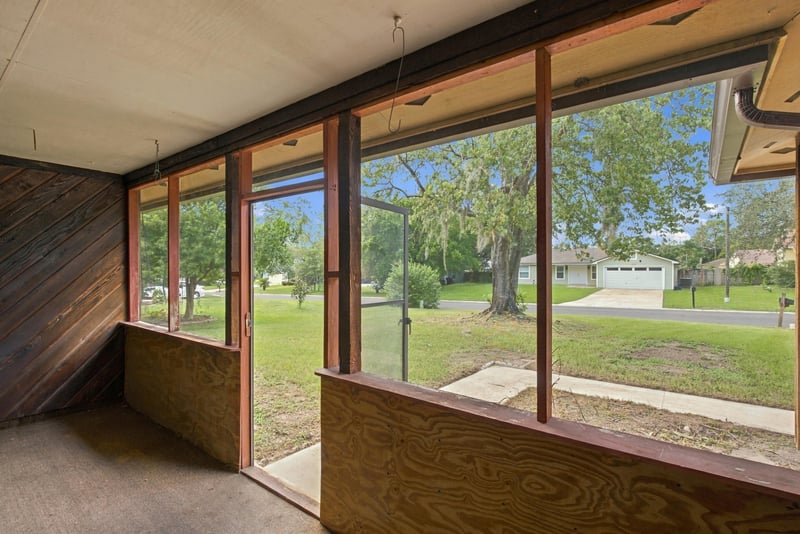 Wood-paneled sunroom with windows overlooking the yard at 2915 Trenton Ct, Orange Park, FL