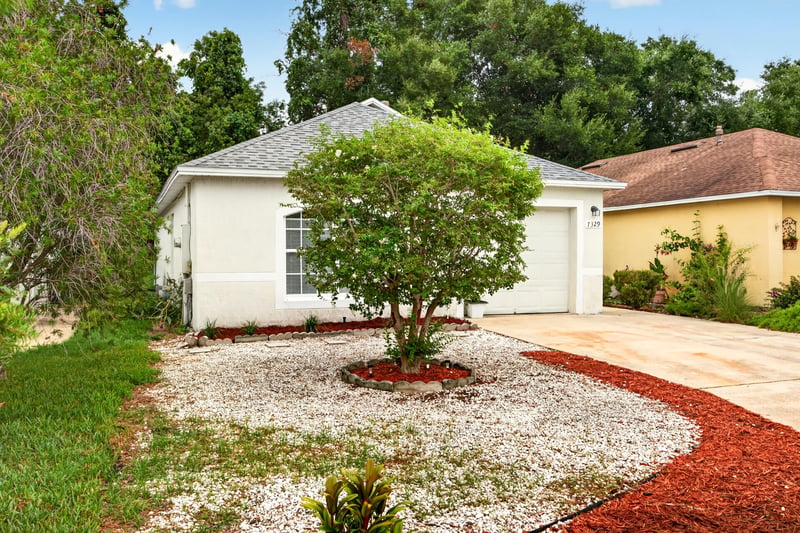 Front yard landscaping with mulch bed and tree at 7329 Lawn Tennis Ln, Jacksonville, FL