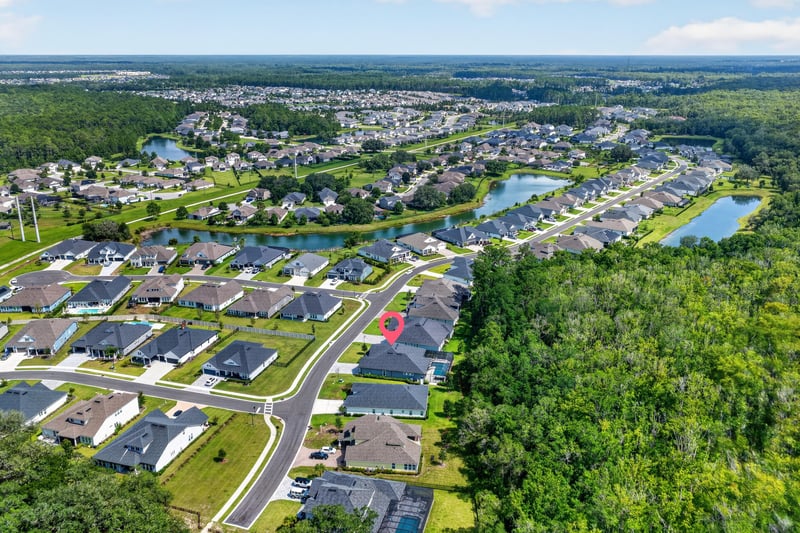 Aerial view of the home and surrounding neighborhood in Whisper Creek