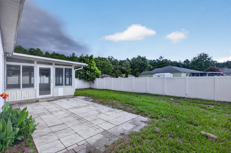 Screened porch and patio with fenced yard at 1845 Saga Ct, Middleburg, FL
