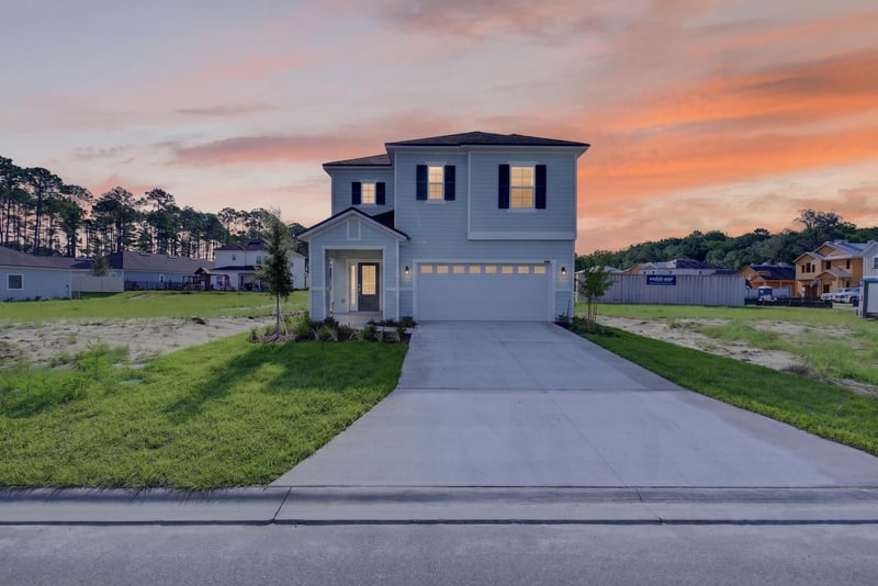 Two-story home exterior at day-to-dusk with driveway and lawn at 269 Bluegrass Wy, St. Augustine, FL 32092