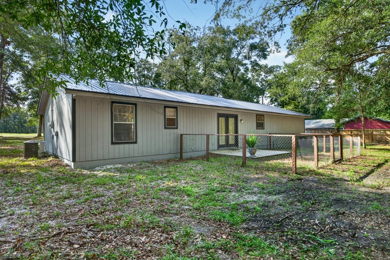 Rear exterior view with fenced yard and outbuilding at 2829 Blackberry Ave