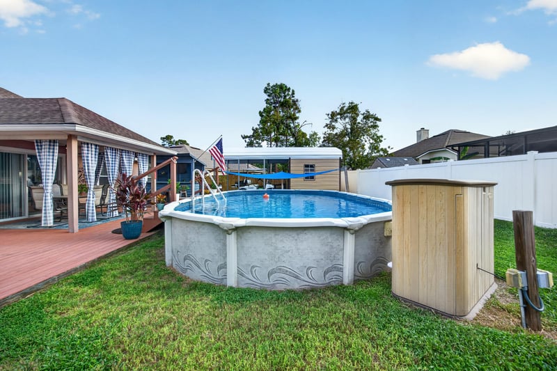 Backyard pool and lawn with storage shed at 3112 Silverado Cir, Green Cove Springs, FL 32043