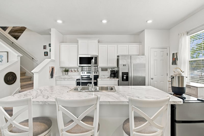 Kitchen island with bar seating and stainless appliances at 8359 Zenith Cir, Jacksonville, FL 32256