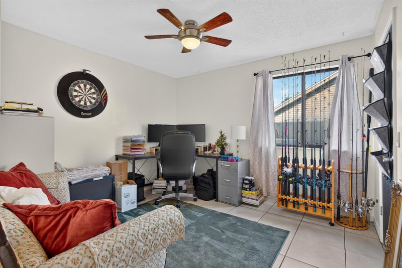 Bedroom with dartboard and ceiling fan at 13020 Medford Ln, Jacksonville, FL 32225