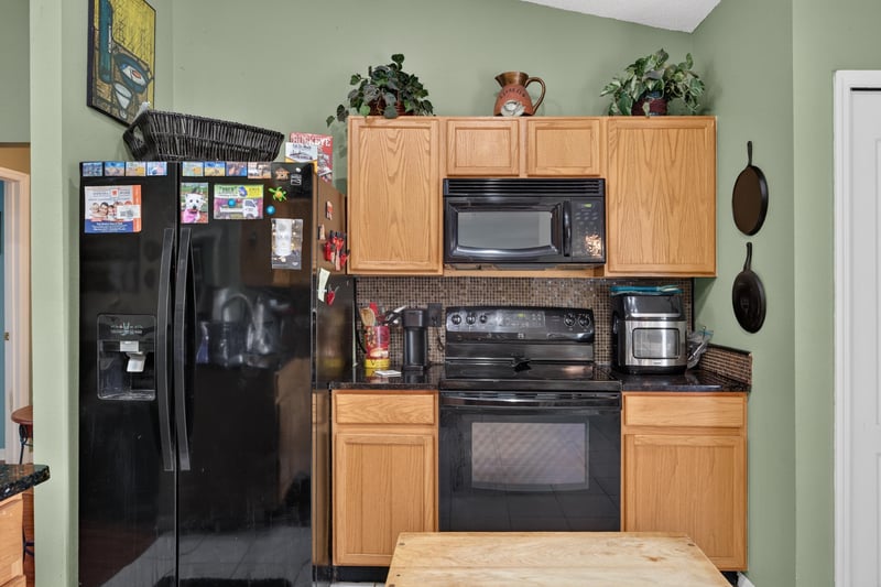 Kitchen with black appliances and tile floor at 145 Dover Bluff Dr, Orange Park, FL