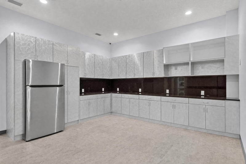 Breakroom with refrigerator and dark countertop cabinets at 7240 Golden Wings Rd building 100, Jacksonville, FL 32244