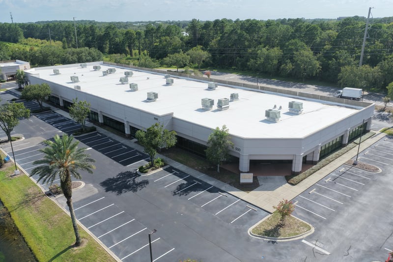 Aerial view of a building roofline and parking lot at 10550 Deerwood Park Blvd, Jacksonville, FL 32256
