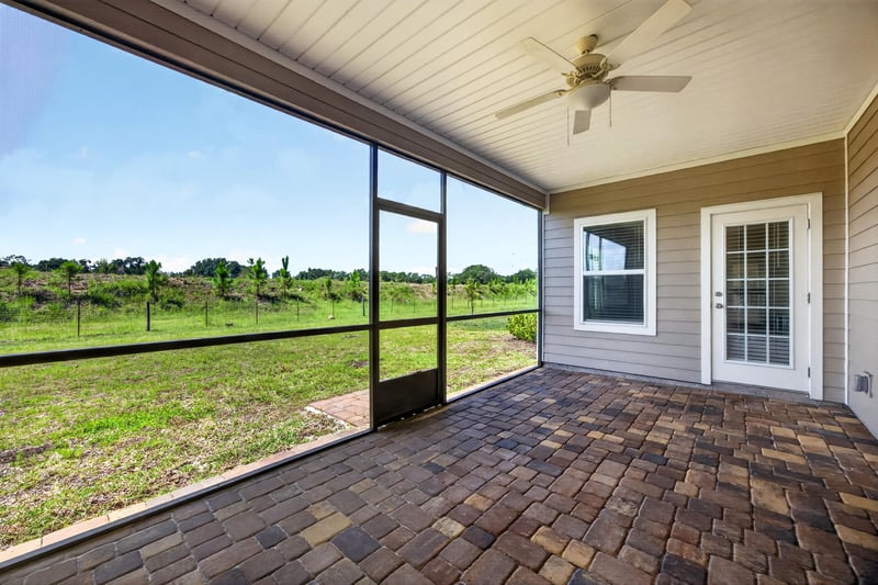 Screened lanai with paver flooring at 9942 Lovage Ln, Jacksonville, FL 32219