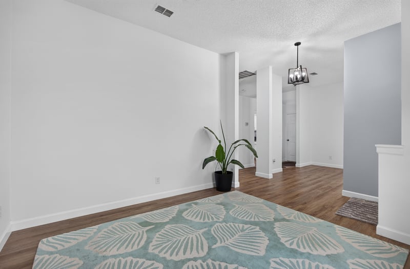 Hallway with pendant light and wood floors at 8921 Needlepoint Pl, Jacksonville, FL 32244