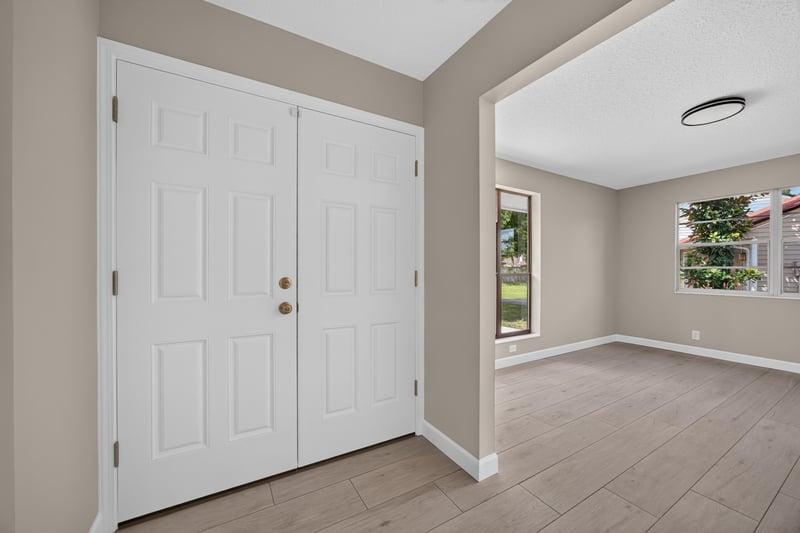 Entry foyer with double white doors and tile flooring at 4117 Wilcrest Ct, Jacksonville, FL 32277