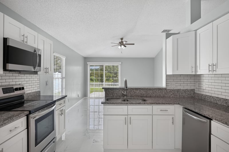 Kitchen with range, microwave, and window over sink at 490 Hillside Dr, Orange Park, FL 32073