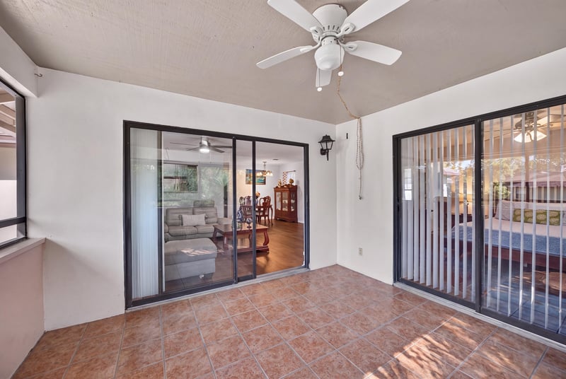 Screened porch with tile flooring and ceiling fan at 10150 Belle Rive Blvd, Jacksonville, FL