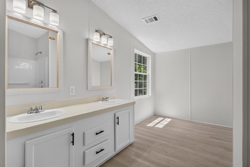 Bathroom vanity with mirror and window at 7603 Coach Park Dr, Jacksonville, FL 32244
