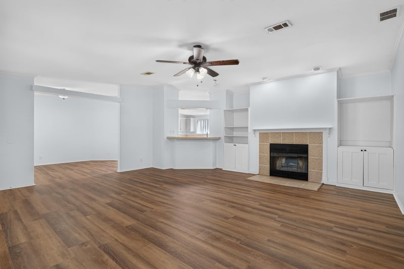 Open living room with fireplace and virtually staged furniture at 3215 Robin Ln, Middleburg, FL