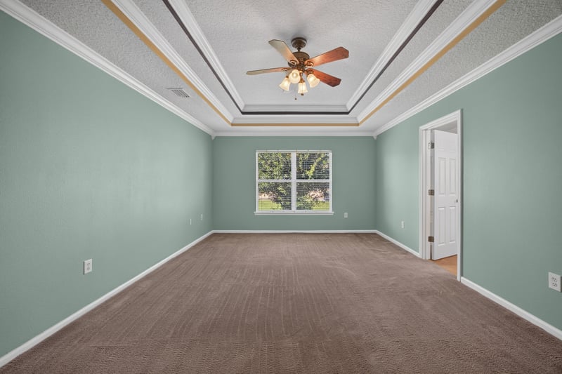 Empty primary bedroom with multiple windows at 2282 Justin Lake Dr, Jacksonville, FL