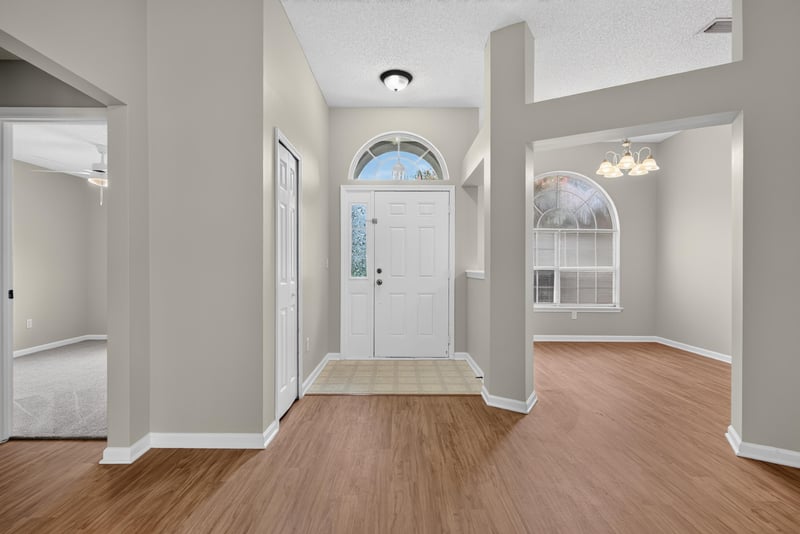Foyer with wood floor and arched window at 12949 Chets Creek Dr S, Jacksonville, FL 32224