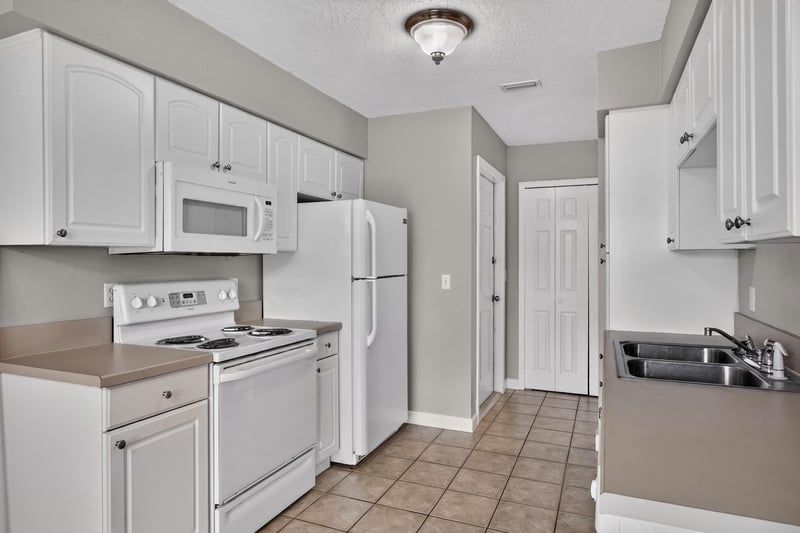 Kitchen view toward refrigerator and range at 1800 Park Ave apt 358, Orange Park, FL