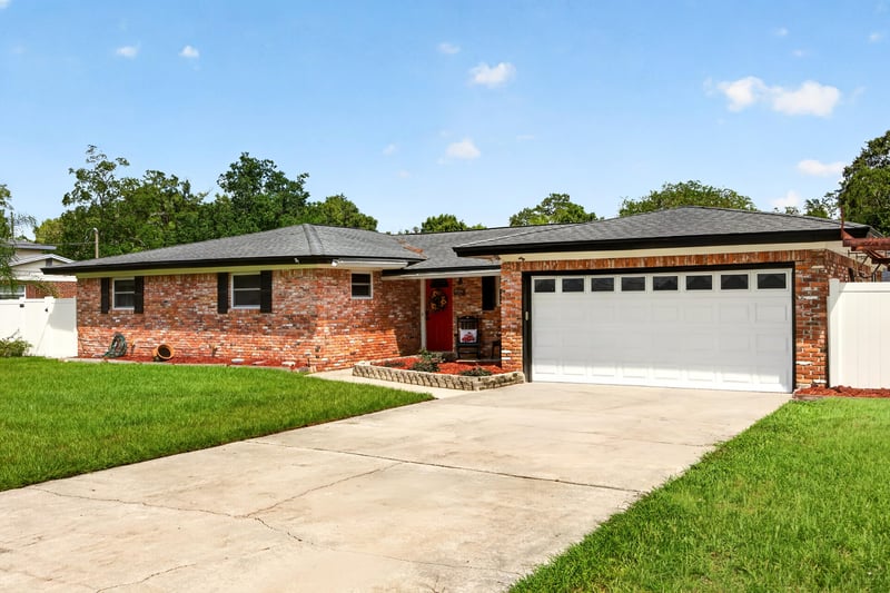 Front exterior with two-car garage and driveway at 6059 Karen St, Jacksonville, FL 32244