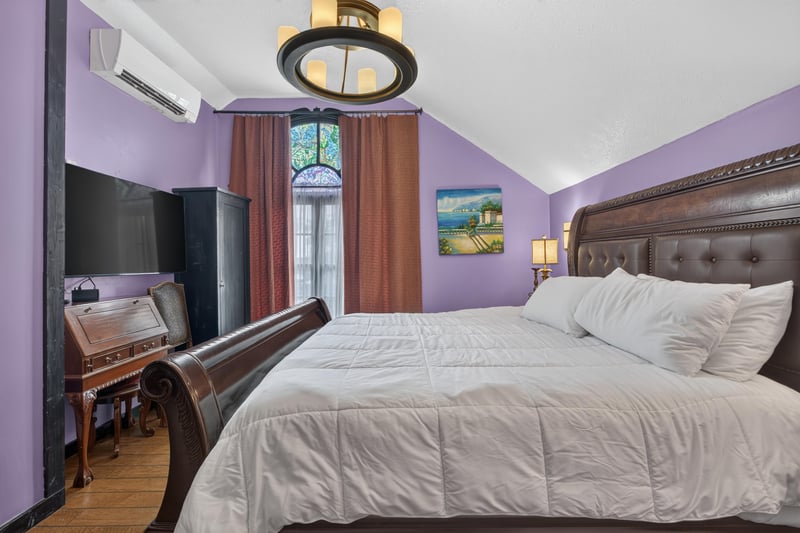 Bedroom with an upholstered headboard and purple walls at 115 Cordova St, St. Augustine, FL