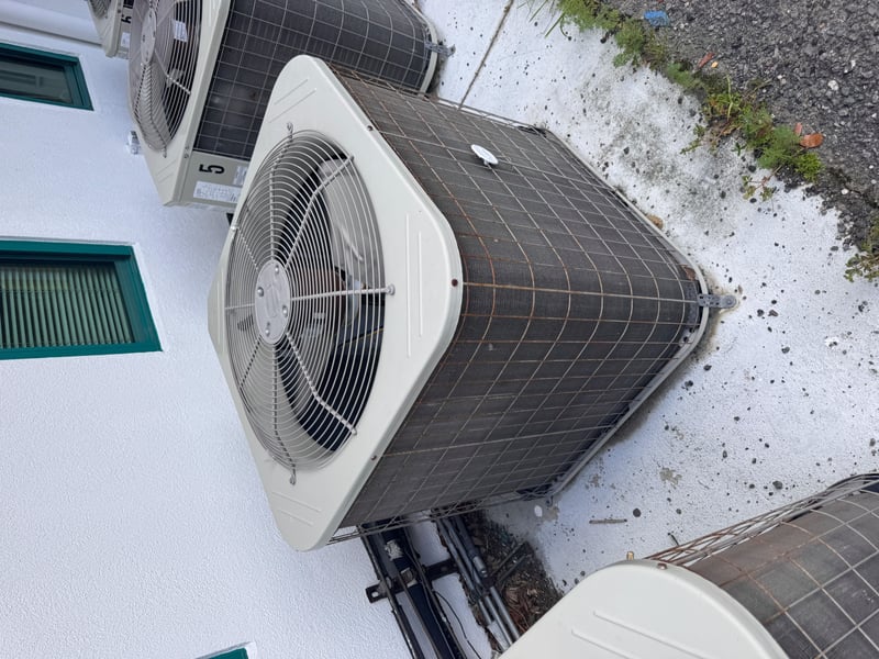 Condenser unit beside green trim window at 11700 New Kings Rd, Jacksonville, FL 32219
