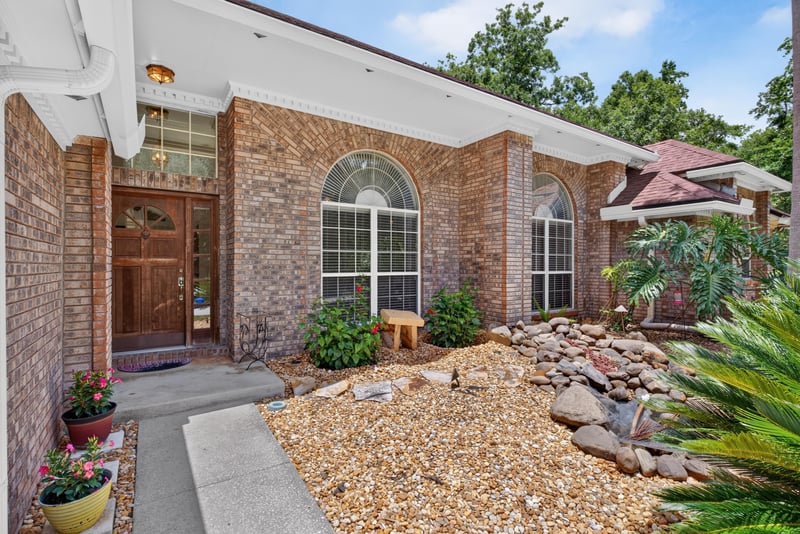 Front door with brick facade and landscaping at 12810 Swamp Owl Ln